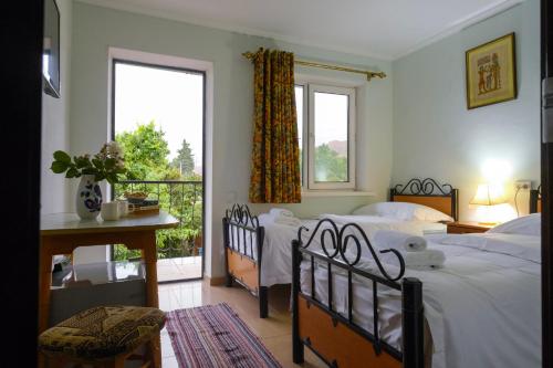 a bedroom with two beds and a balcony at Art Hotel Al Hayat in Kaji-Say