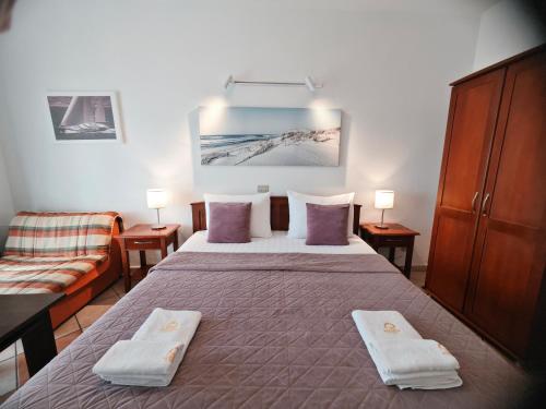 a hotel room with a bed and a couch at Adriatic Apartment in Ulcinj