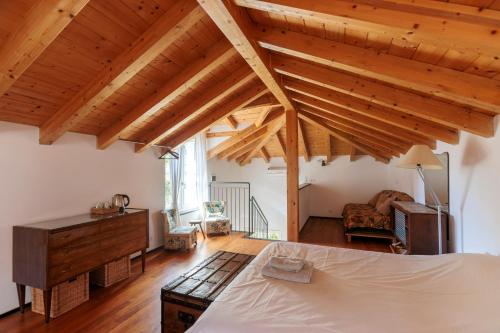 a bedroom with wooden ceilings and a bed in a room at Agriturismo Valleponci in Finale Ligure