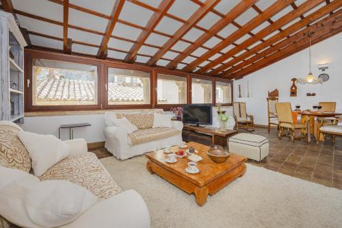 a living room with white couches and a table at Casa Angels in Pollença