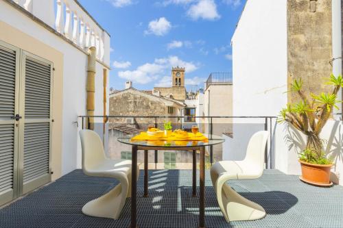 a balcony with a table with yellow shoes on it at Casa Angels in Pollença