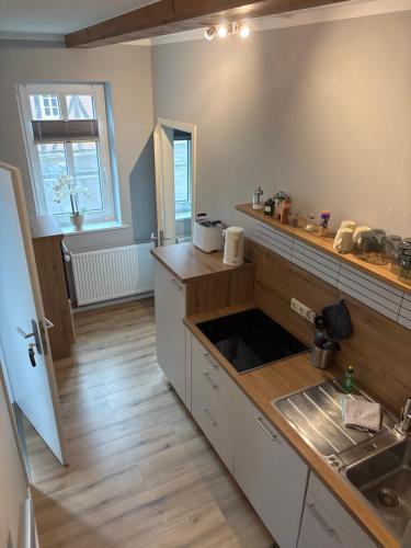a kitchen with a sink and a counter top at Allenberghütte Schoningen in Uslar