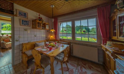 a kitchen with a table and chairs in a room at Steins Hof in Suderburg