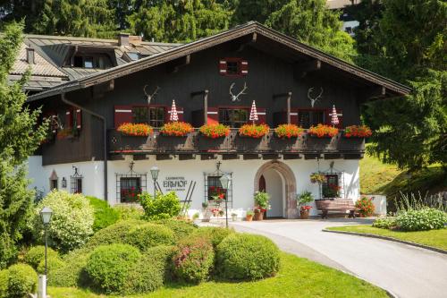 a house with flower boxes on the windows at Der Erlhof Restaurant & Landhotel in Zell am See