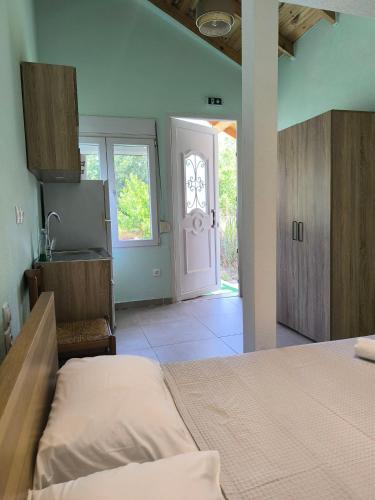 a bedroom with a bed and a door to a room at Summer Relax in Keramoti