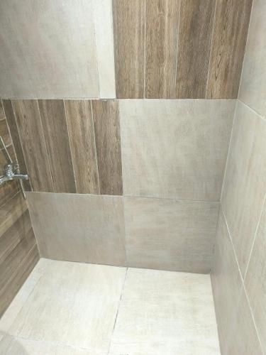 a bathroom with a shower with a wooden wall at Summer Relax in Keramoti