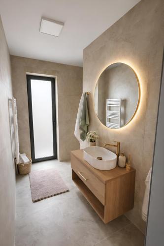a bathroom with a sink and a mirror at GERALT Tatras Residence in Nová Lesná