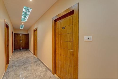 a hallway with a wooden door and a ceiling at Hotel O Royal Regency Palace in Gorakhpur