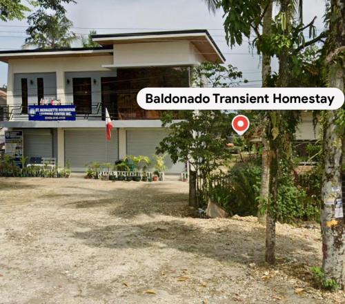 a house with a sign in front of it at Baldonado Transient Homestay in San Isidro