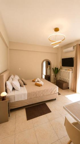 a bedroom with a large bed and a living room at Idene Penthouse in Chania
