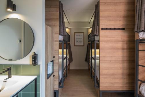 a room with a hallway filled with bunk beds at LATROUPE Grand Place in Brussels