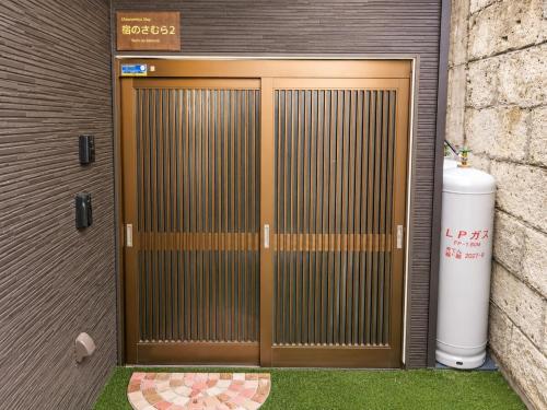 an entrance to a building with a metal door at 宿のきむら2 in Utsunomiya