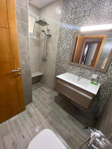 a bathroom with a sink and a toilet and a mirror at kelibia in Kelibia