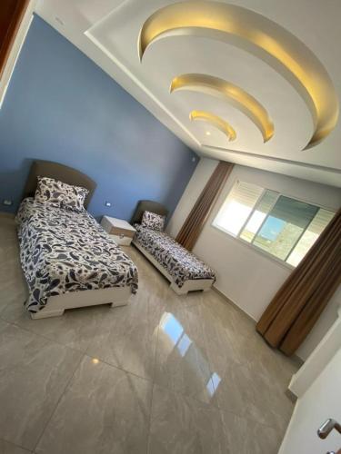 a bedroom with a bed and a large ceiling at kelibia in Kelibia