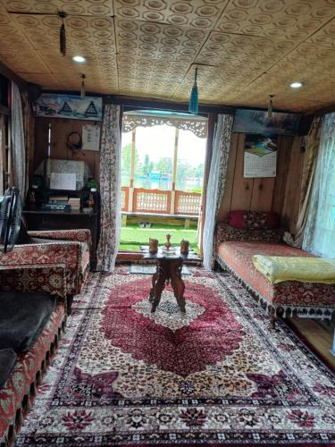 a living room with two couches and a table at H.B.victoria Garden in Srinagar