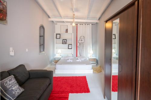 a living room with a bed and a couch at Bursa Cottage House in Mesochórion