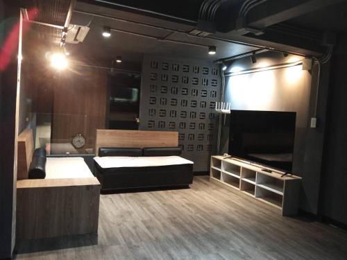 a room with two beds and a television in it at BANKBED Hostel in Bangkok