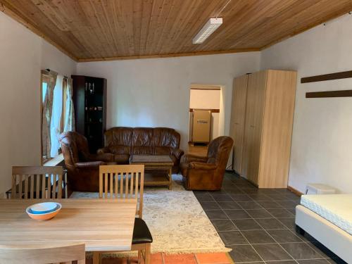 a living room with leather furniture and a table at Very Attractive Location in Täby