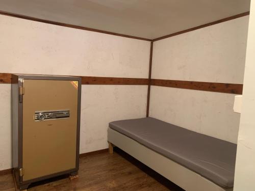 a small room with a bed and a door at Very Attractive Location in Täby