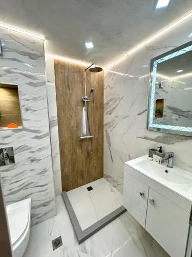 a bathroom with a shower and a toilet and a sink at Urban Apart in Stara Zagora