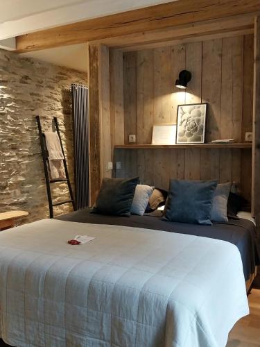 a bedroom with a large bed in a room at B&B En face du Marronnier in Cornimont