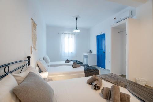 a bedroom with a bed and a living room at Pleasure Blackbeach Studios in Perissa