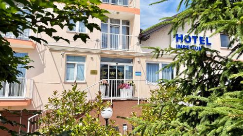 a hotel with a sign on the side of a building at Hotel Imperium in Moravske-Toplice