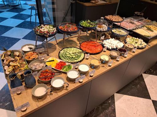 a buffet with many different types of food on a table at Focus Hotel Premium Elbląg in Elblag