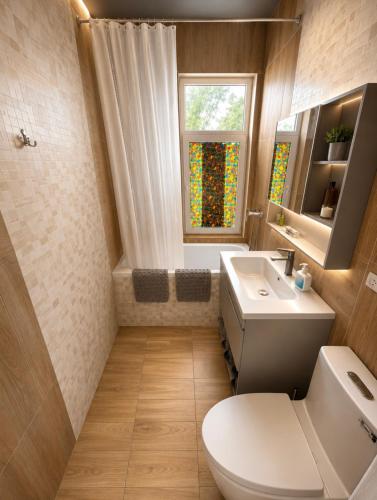 a bathroom with a toilet and a sink and a window at All residence in Almaty