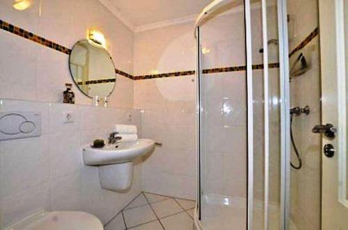 a bathroom with a toilet and a sink and a shower at Ferienwohnung-Silvie-8 in Westerland