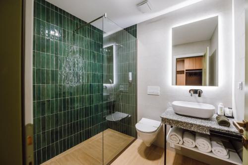 a bathroom with a sink and a toilet and a shower at Vila Bernady Sovata in Sovata