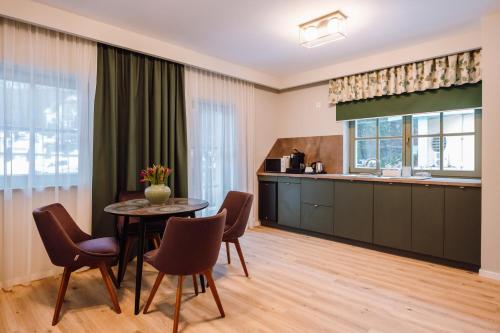 a kitchen and dining room with a table and chairs at Vila Bernady Sovata in Sovata