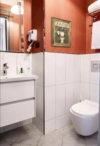 a bathroom with a toilet and a sink at West inn Luxury Baku in Baku