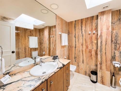 a bathroom with a sink and a toilet at Macdonald Villacana Resort in Estepona