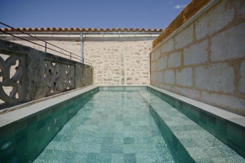 a swimming pool in a building with a brick wall at Bytra Boutique Hotel - Adults Only in Petra