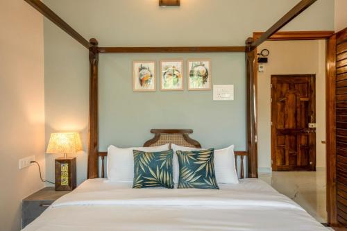 a bedroom with a large bed with two pillows at Aloha Kai Modern Chic 2BHK Benaulim in Benaulim