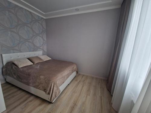 a small bedroom with a bed in the corner at Sky Nest Batumi in Batumi