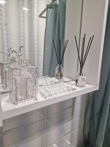 a shelf with crystals and vases on it at Sky Nest Batumi in Batumi