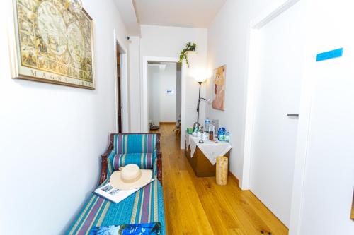 a room with a chair and a table with a hat on it at Ánemos b&b in Termoli