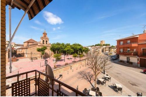 a view of a city with a church and a street at CasaConchaGuadamur in Guadamur