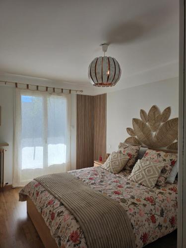 a bedroom with a bed and a large window at Le repos de Cézanne in Salon-de-Provence