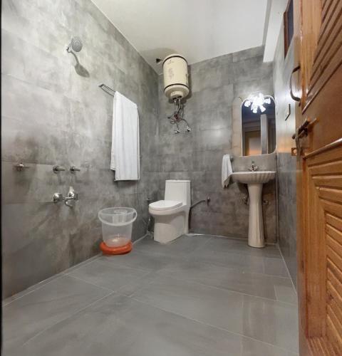 a bathroom with a toilet and a sink at The Sana Cottge, Manali - Affordable Luxury Stay in Manali in Manāli