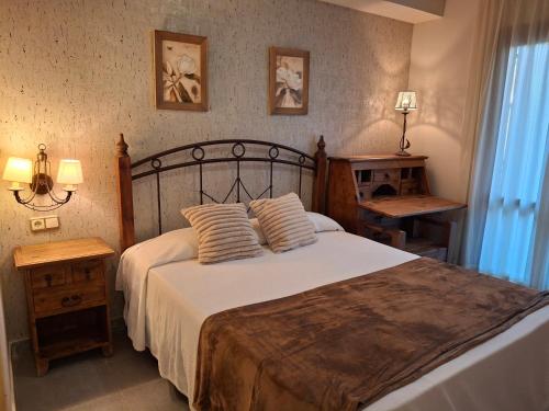 a bedroom with a bed with two pillows on it at Hostal Casa Juan in Castejón de Sos