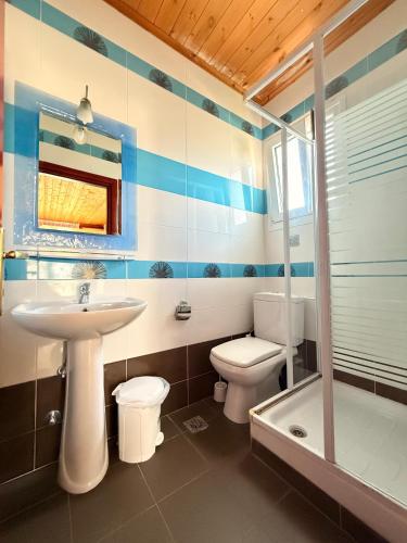 a bathroom with a sink and a toilet and a tub at Amphitrite's Paradise Apartments in Olympic Beach
