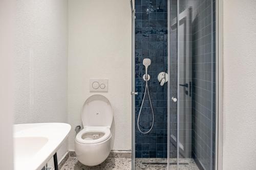 a bathroom with a toilet and a sink and a shower at Casa Colore Boutique House in Bodrum City