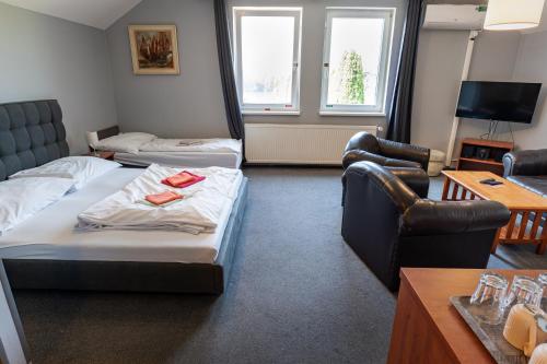 a living room with two beds and a couch at Pension Silma in Rychwald