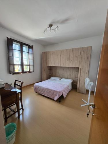 a bedroom with a bed and a desk in it at Alfredo II Affittacamere in Siena