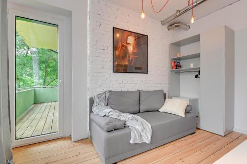 a living room with a couch and a fireplace at G-8HOSTEL Gdynia in Gdynia