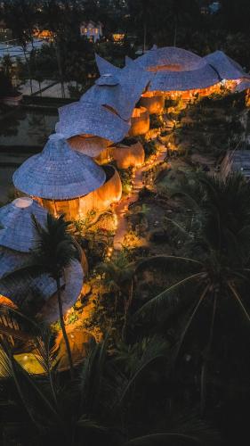 a bunch of umbrellas are lit up at night at Green Lander Ubud in Ubud