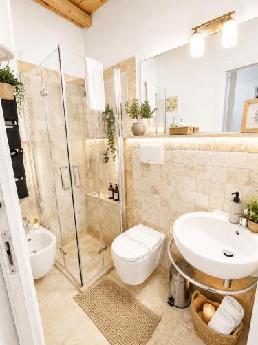 a bathroom with a shower and a toilet and a sink at TorreParadiso Holidays in Polignano a Mare